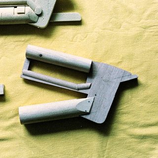 3D-printed plastic hinge and bracket components.