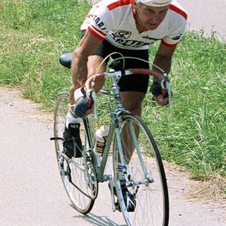 Two cyclists racing on a rural road.