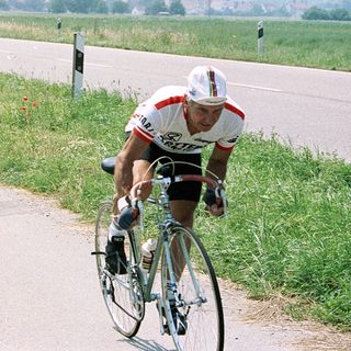 Two cyclists racing on a rural road.