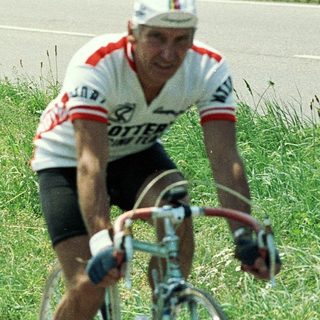 Two cyclists racing on a road.