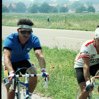 Two cyclists racing on a road.