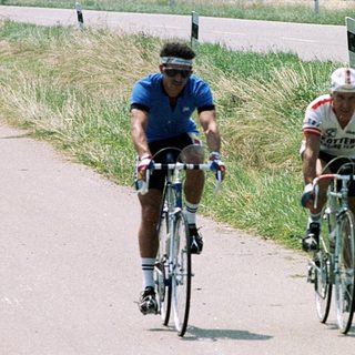 Two cyclists racing on a rural road.