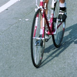 Professional cyclist racing on road bike.