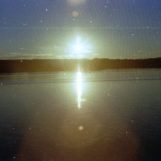 Sunlight reflecting on calm water at dusk.