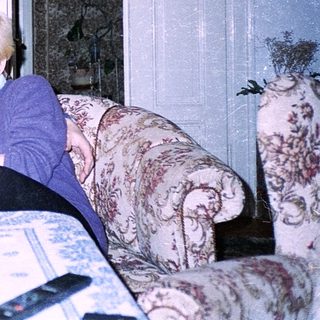 Two elderly people playing board game indoors.