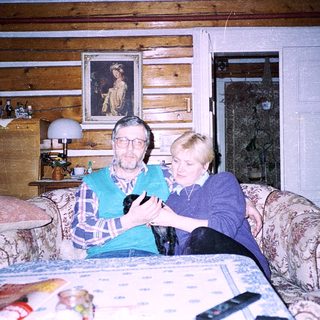 Two elderly people playing board game indoors.