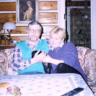 Two elderly people playing board game indoors.