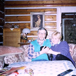 Two elderly people playing board game indoors.