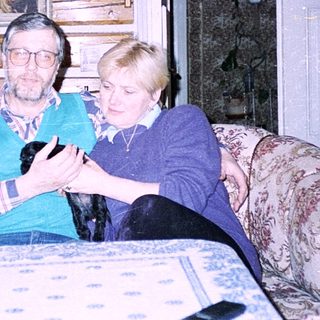 Two elderly people playing board game indoors.