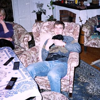 Two people relaxing indoors with old-fashioned furniture.