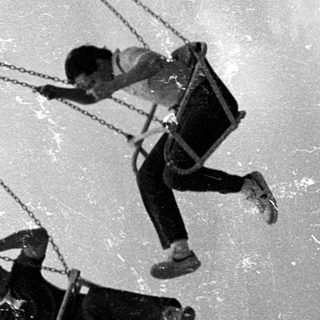 People zip-lining or high-rope coursing on suspended cables.