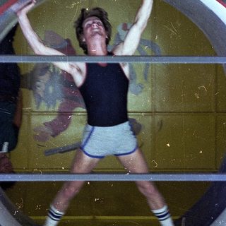 Person performing handstand against a circular wall.