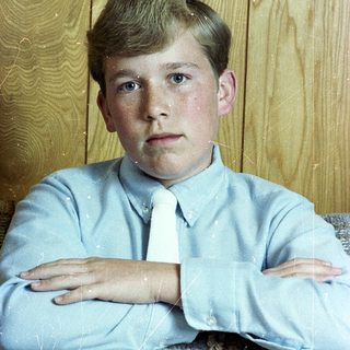 Young boy in light blue shirt and tie.