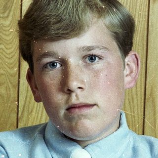 Young boy in light blue shirt and tie.