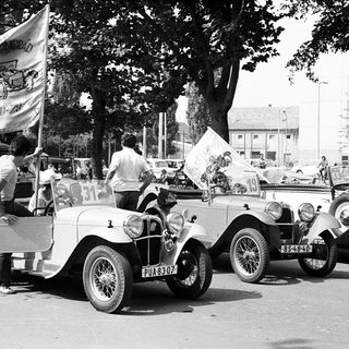 Vintage cars parade with vintage flags.