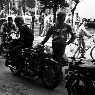 Motorcyclists participating in vintage race event.