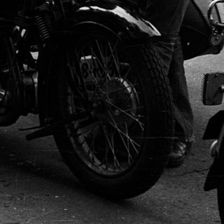Motorcyclists participating in vintage race event.