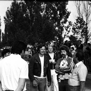 Group of people outdoors at what appears to be a public event or gathering.