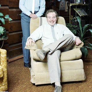 Two men in formal attire posing indoors.