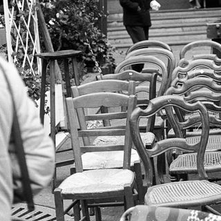 Empty outdoor café seating area with vintage furniture.