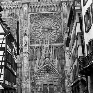 Gothic cathedral façade with intricate stonework and rose window.