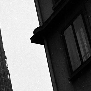 Gothic cathedral spire rising above urban buildings.