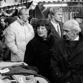Group of people at an indoor market or fair.