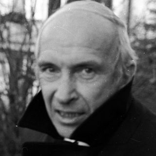 Black-and-white portrait of elderly man in winter attire.