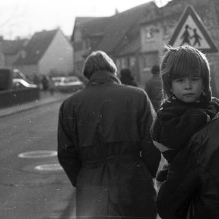Family walking outdoors in residential area.