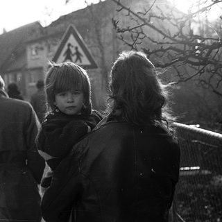 Family walking outdoors in residential area.