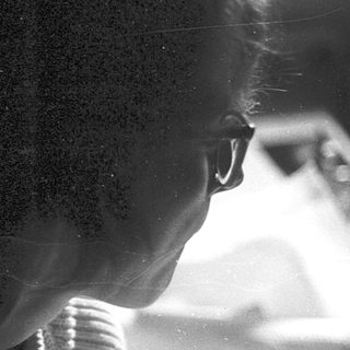 Silhouette of person working at blurred desk.