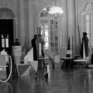 Film set construction in grand interior.