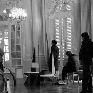Film set construction in grand interior.