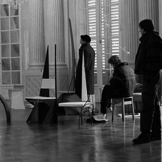 Film set construction in grand interior.