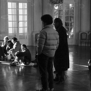 Group rehearsing in a grand indoor setting.