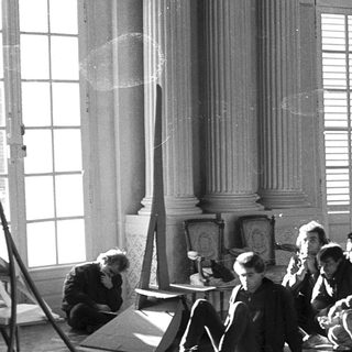 Group rehearsing in a grand indoor setting.