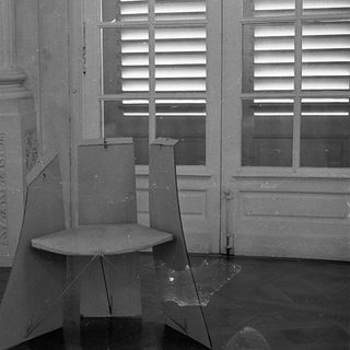 Abandoned room with broken furniture and shattered glass.