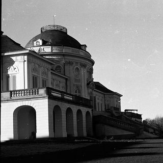 Elegant classical building with dome and arched colonnade.