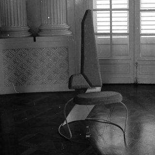 Modern chair in classical interior space.