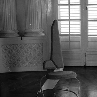 Modern chair in classical interior space.