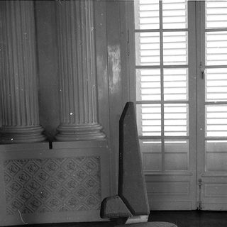 Modern chair in classical interior space.