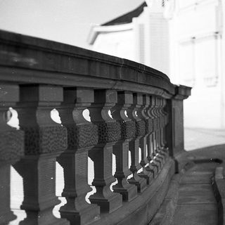 Elegant curved wooden balustrade with intricate balusters.