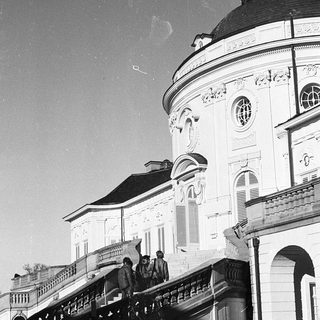 Elegant historic building with grand staircase and ornate dome.