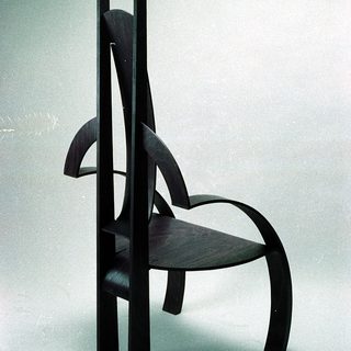 Modern wooden chair with sculptural, organic design.