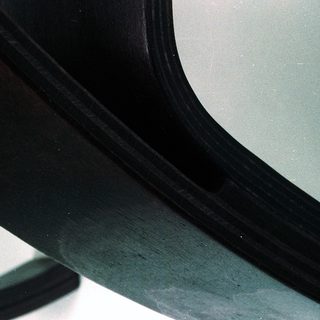 Curved black interior mirror with reflective surface.