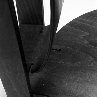 Dark wooden chair legs with curved metal supports.