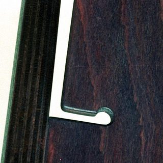 Dark wooden interior door with metal handles.