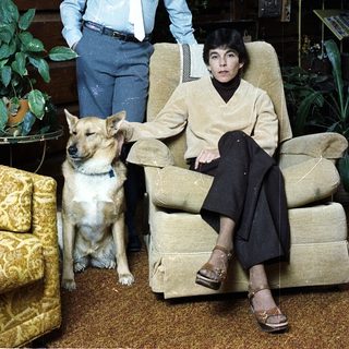 Family portrait with boy, woman, and dog indoors.