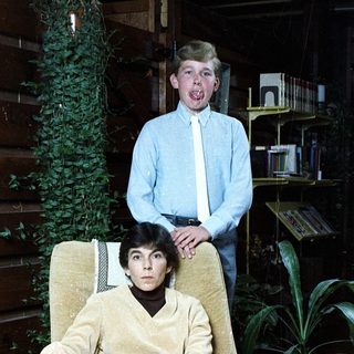 Two people in a cozy indoor setting, likely a home.