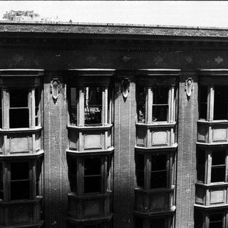 Historic building facade with bay windows.